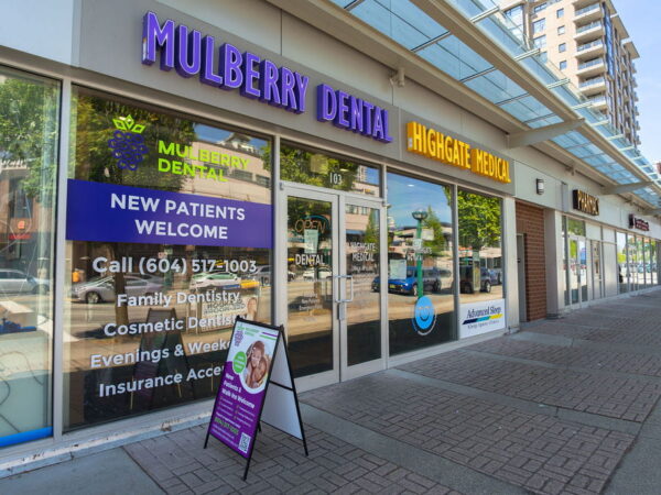 The storefront of Mulberry Dental, featuring inviting signage for new patients and a friendly 123Dentist Smiley logo on the window.
