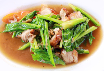 Bowl of crispy pork stir-fry with kale