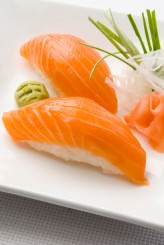 a photo of salmon nigiri on a plate