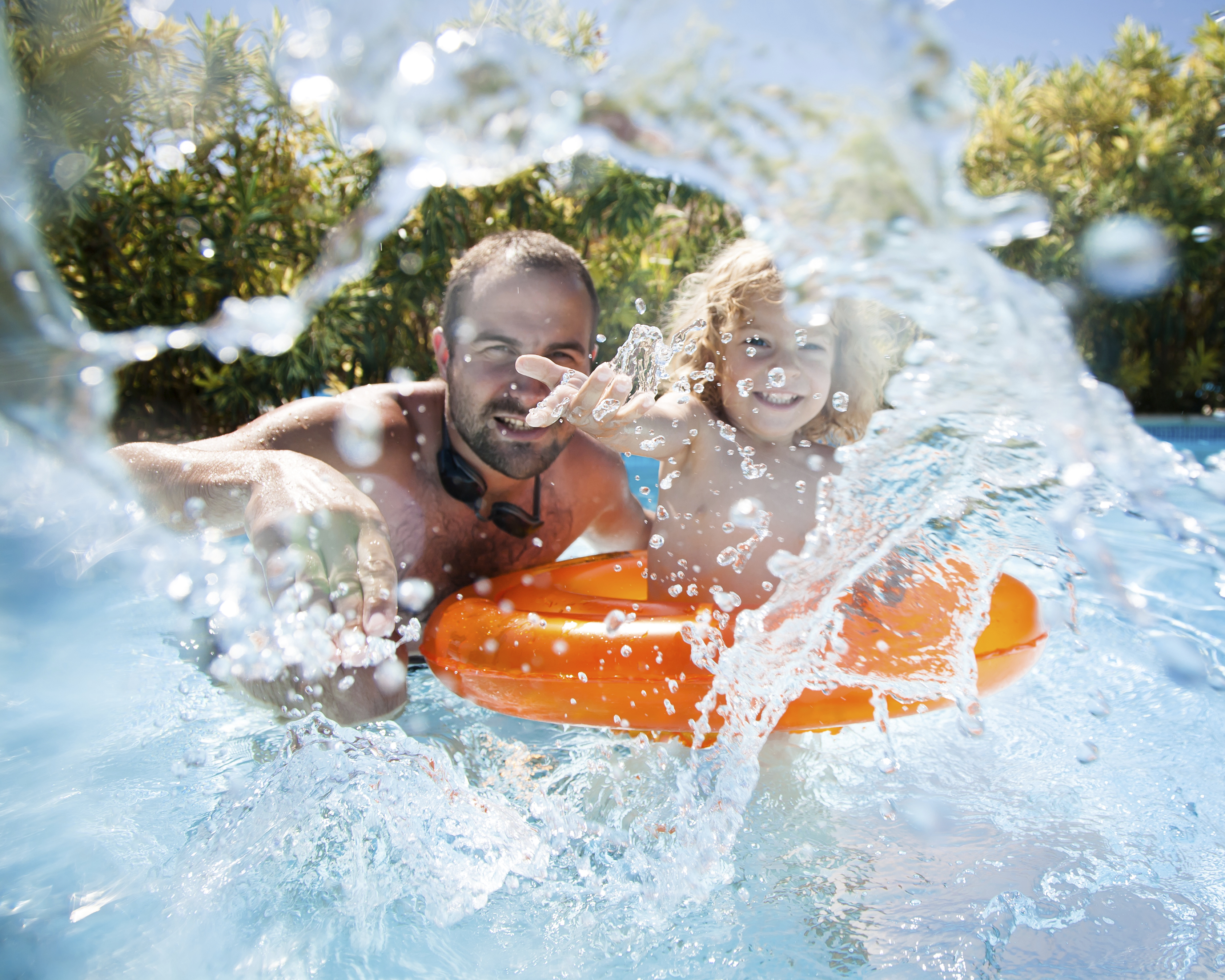 Child with father in swimming pool