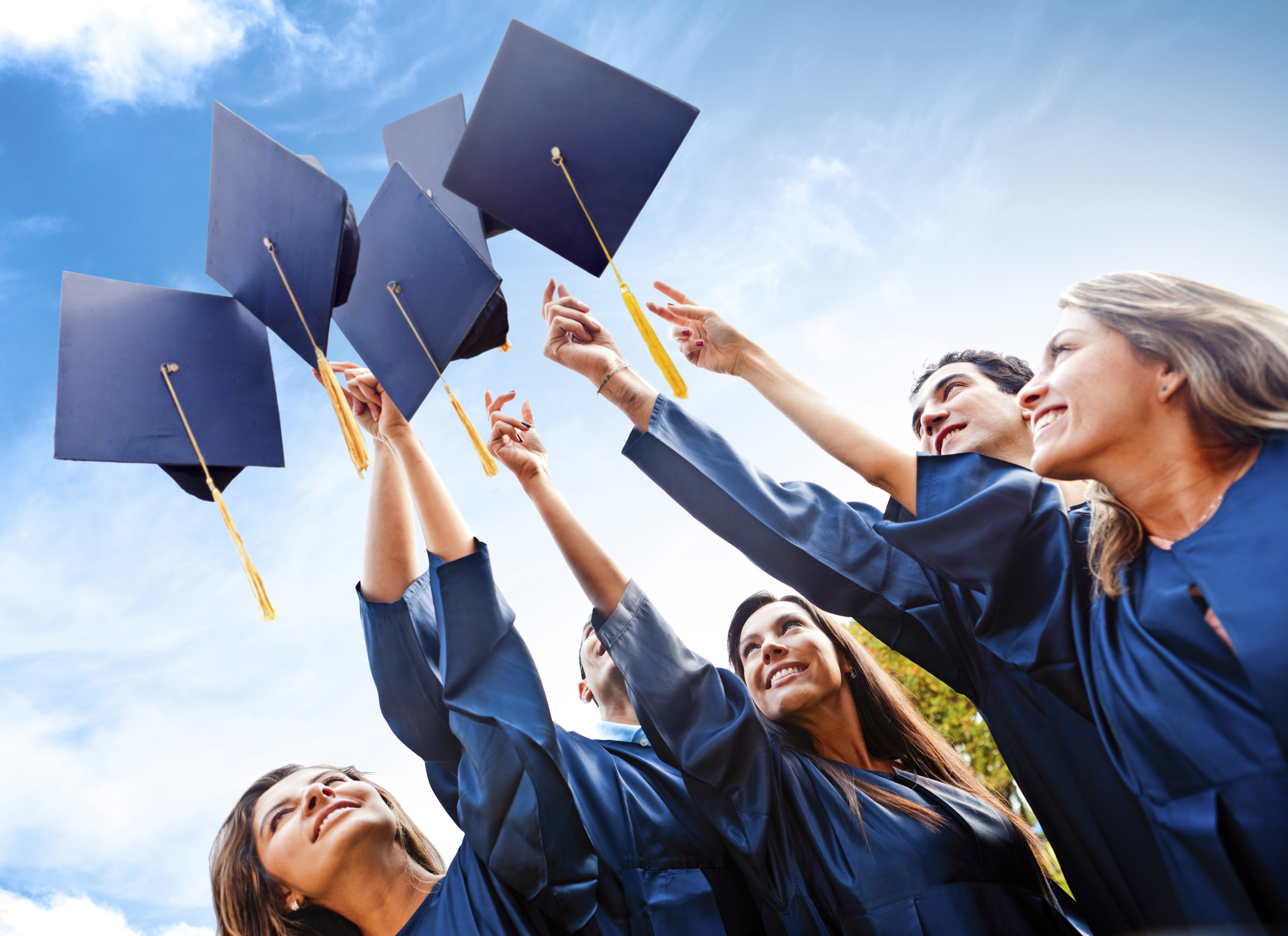 Students throwing graduation hats