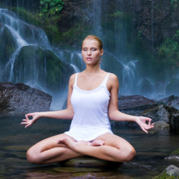 Young woman doing yoga in the water