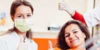 Dental Hygienist and Patient give a thumbs-up after check-up