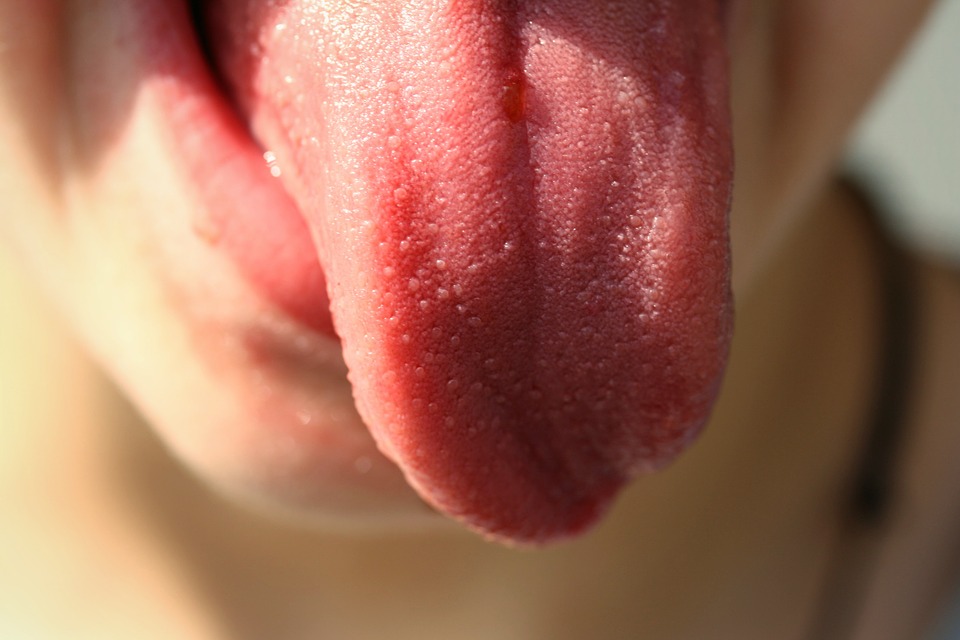 close up of person sticking out tongue