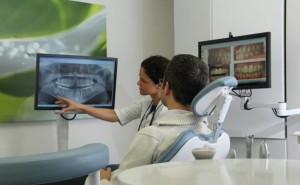 Dr. Shirzad from Harbour Centre Dental going through an xray with a patient.