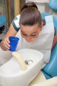 woman spitting into sink