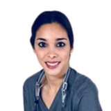 A smiling person wearing medical scrubs and a stethoscope against a white background.