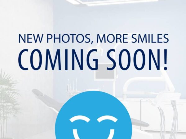 A bright dental office with modern equipment in the background, featuring the friendly 123Dentist Smiley at the center. The text reads "NEW PHOTOS, MORE SMILES COMING SOON!" inviting viewers for upcoming content related to dental care.