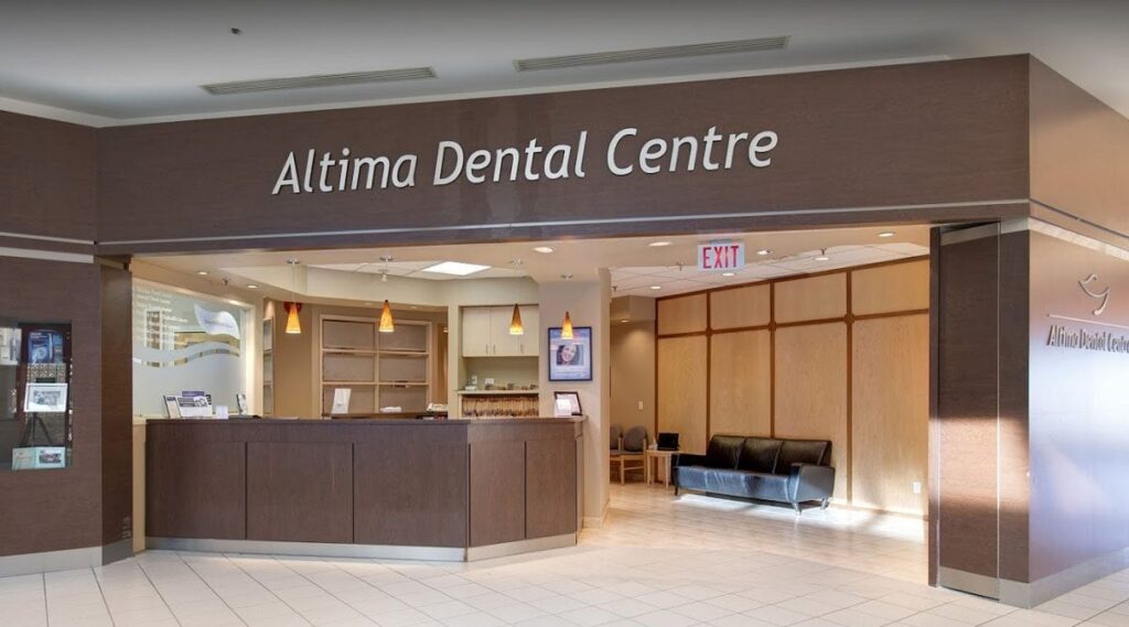 Interior of Altima Dental Centre, featuring a modern reception area with a welcoming desk and seating. The space has neutral colors and contemporary design elements, creating a friendly atmosphere for patients.