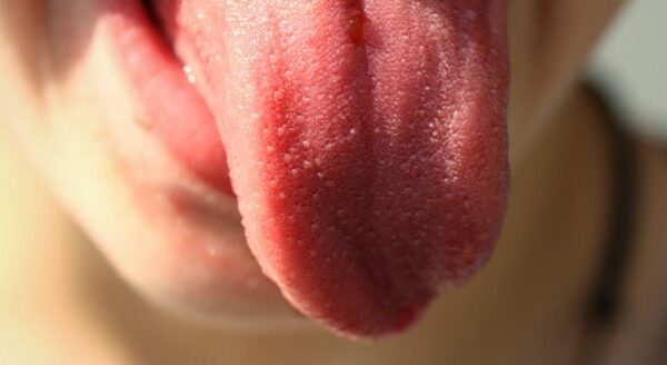 close up of person sticking out tongue