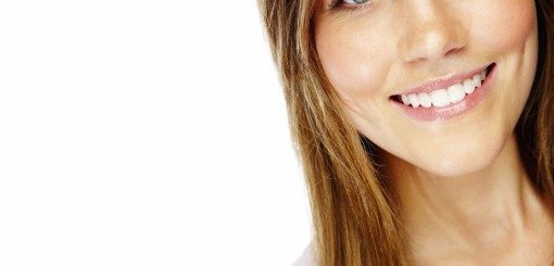 A smiling woman with long, straight hair and clear skin is facing the camera. She exudes warmth and friendliness, creating a positive atmosphere.