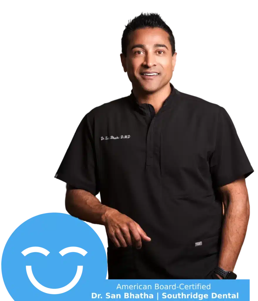A friendly dentist, Dr. San Bhatha, smiles confidently in a black dental uniform. Beside him is the cheerful 123Dentist Smiley, adding a touch of warmth to the scene. The image highlights a professional atmosphere, reassuring patients about their dental care.