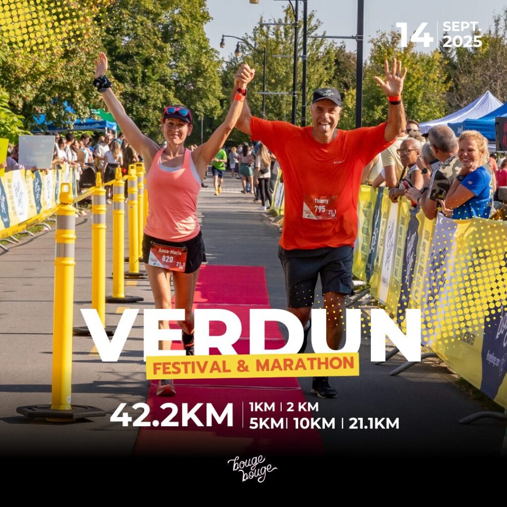 A man and woman celebrate as they cross the finish line together at the Verdun Festival & Marathon. Both are smiling and raising their arms in triumph amidst a crowd of spectators, with banners displaying the event details in the background.