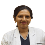 A friendly dentist in a white coat, smiling warmly.