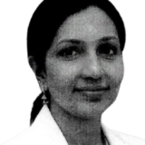 A professional woman in a white coat, with long dark hair tied back, smiling gently.