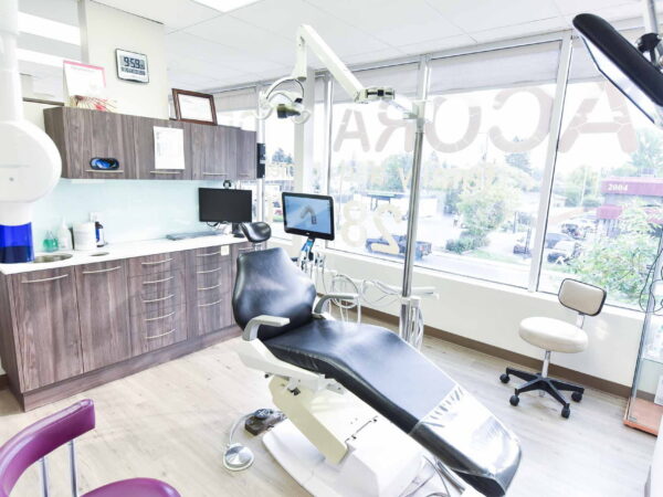 A bright and modern dental office with a comfortable chair, large windows, and dental equipment, creating a welcoming atmosphere.