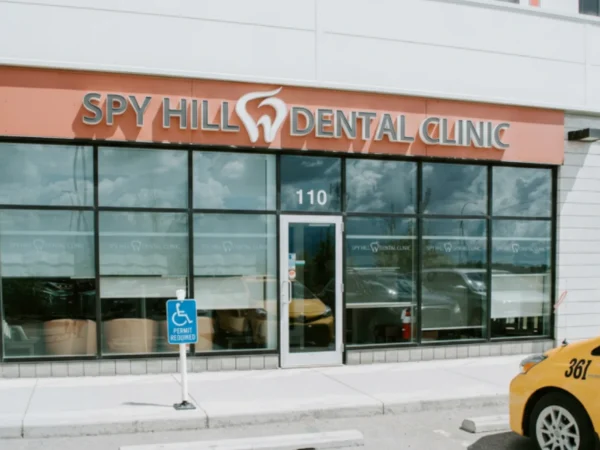 Entrance of Spy Hill Dental Clinic with large windows and accessible parking nearby.