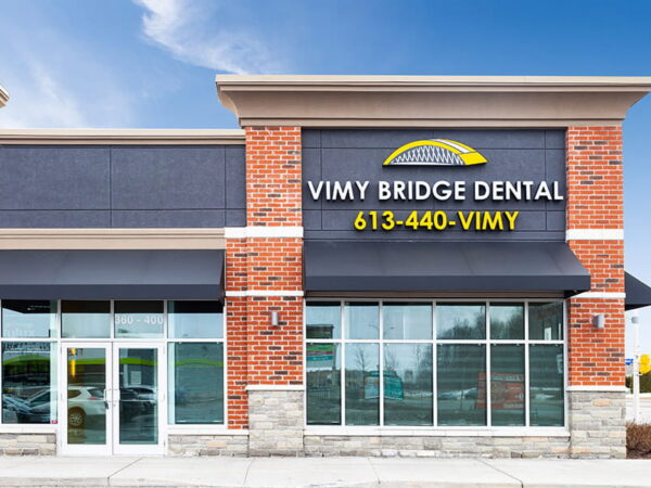 The exterior of Vimy Bridge Dental with its name and phone number displayed on the building facade.